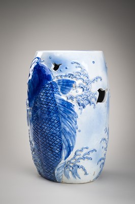Lot 241 - A LARGE AND HEAVY BLUE AND WHITE ‘KOI’ GARDEN STOOL