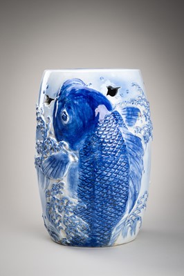 Lot 241 - A LARGE AND HEAVY BLUE AND WHITE ‘KOI’ GARDEN STOOL