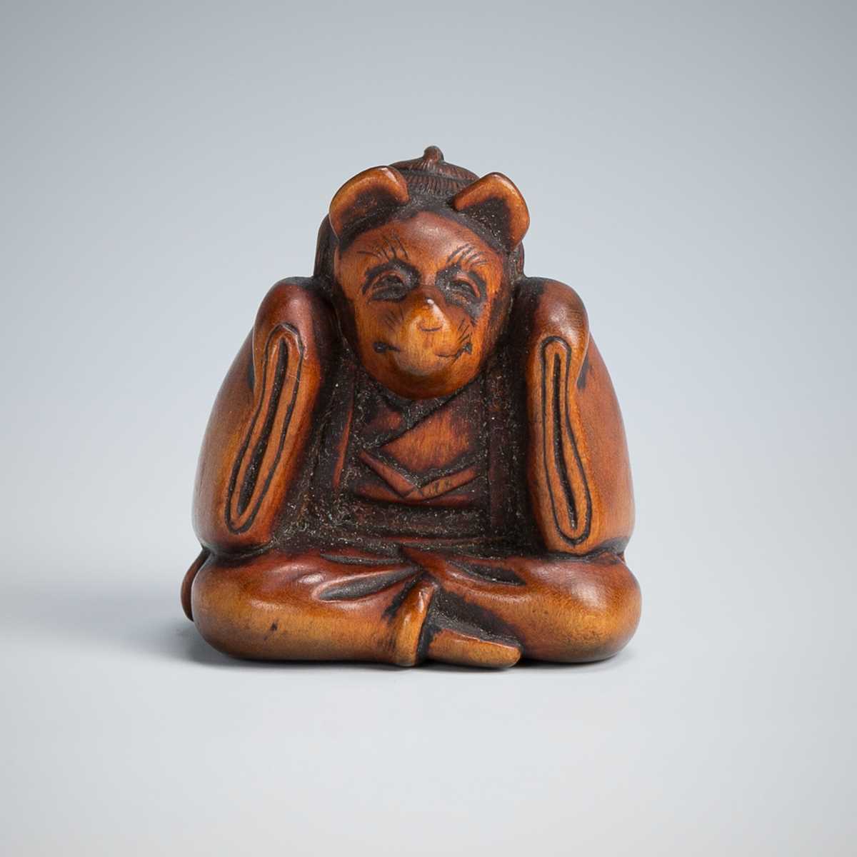 Lot 390 - A CHARMING WOOD NETSUKE OF A KARAKO WEARING A KITSUNE MASK