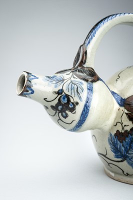 Lot 250 - A CERAMIC POURING VESSEL DEPICTING GRAPEVINES, KENDI