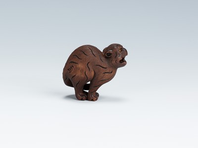 Lot 419 - VADYM PYVOVAR: A BOXWOOD NETSUKE OF A SNARLING TIGER
