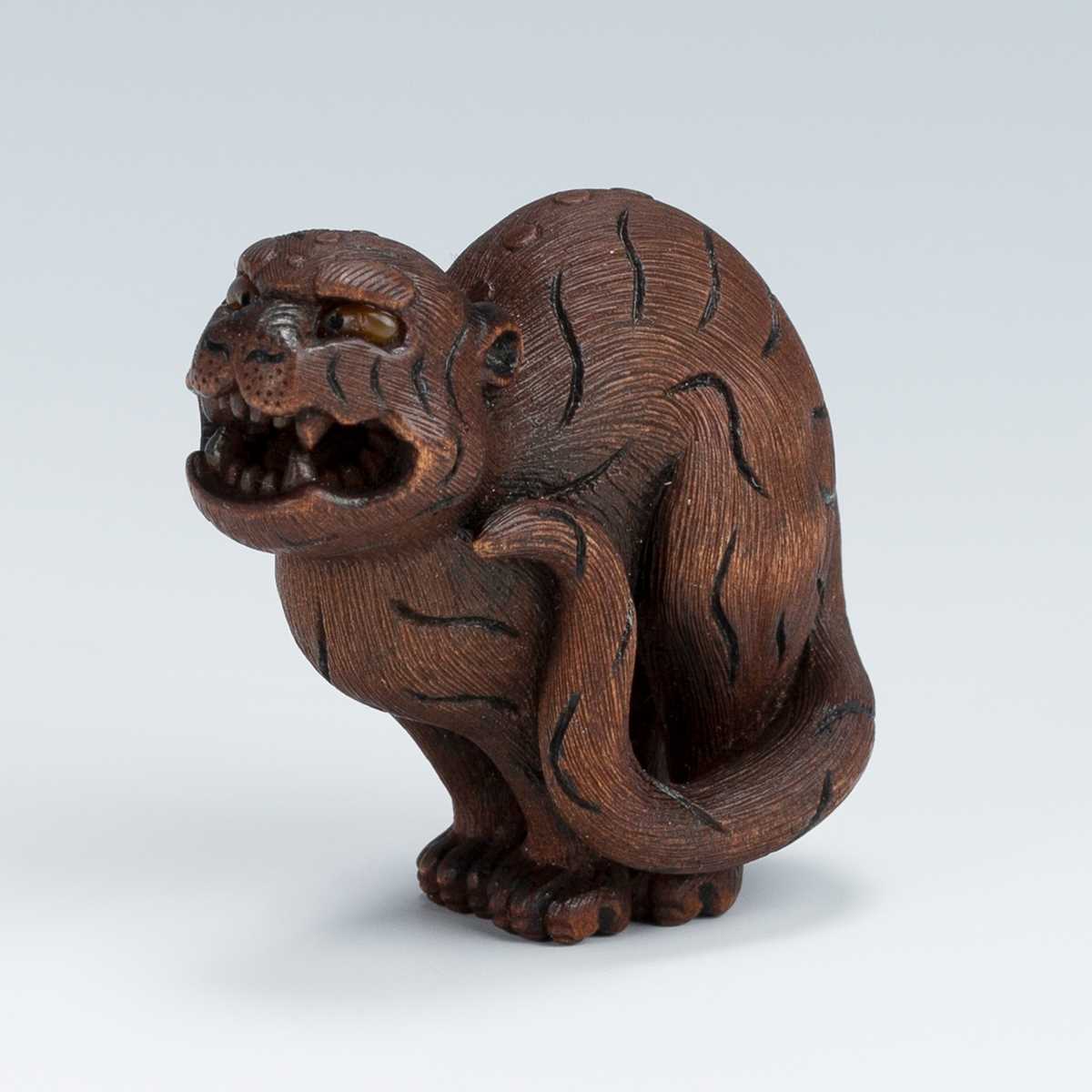 Lot 419 - VADYM PYVOVAR: A BOXWOOD NETSUKE OF A SNARLING TIGER
