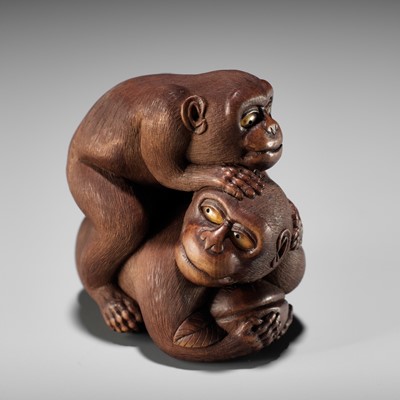 Lot 517 - VADYM PYVOVAR: A BOXWOOD NETSUKE OF TWO MONKEYS FIGHTING OVER A PEACH, AFTER NAITO TOYOMASA