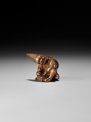 Lot 249 - MASAYOSHI: AN AMUSING WOOD NETSUKE OF A PARASOL MAKER WITH A MOVABLE HEAD