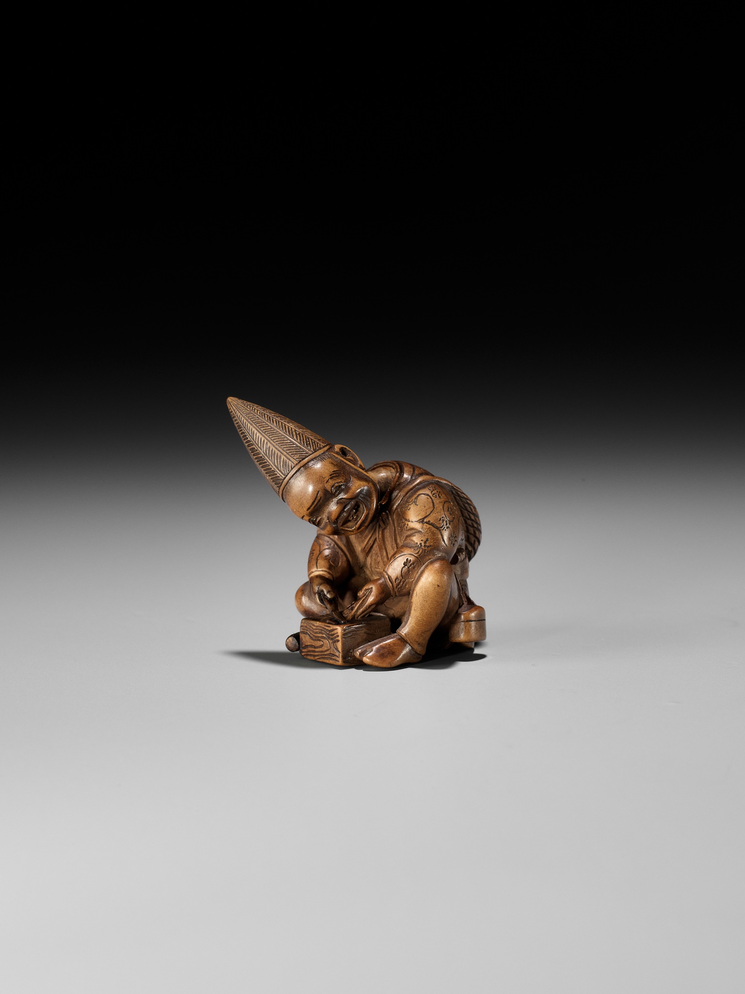 Lot 249 - MASAYOSHI: AN AMUSING WOOD NETSUKE OF A