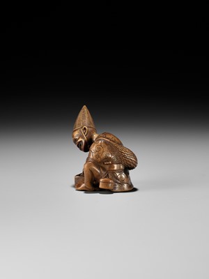Lot 249 - MASAYOSHI: AN AMUSING WOOD NETSUKE OF A PARASOL MAKER WITH A MOVABLE HEAD