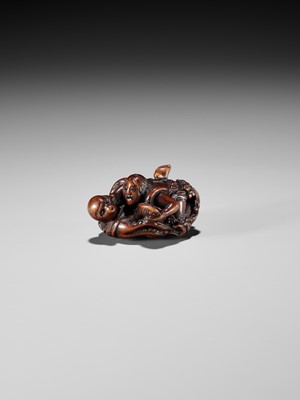 Lot 370 - KOKEI: A FINE WOOD NETSUKE OF AMA STRUGGLING WITH AN OCTOPUS