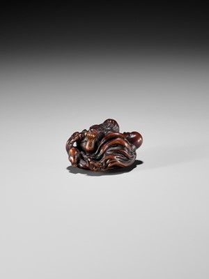 Lot 370 - KOKEI: A FINE WOOD NETSUKE OF AMA STRUGGLING WITH AN OCTOPUS