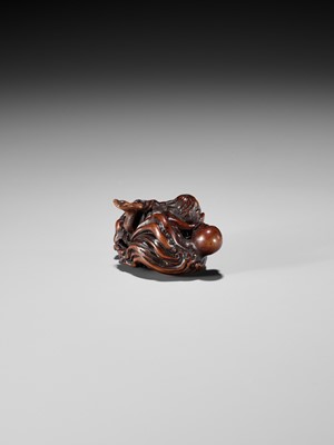 Lot 370 - KOKEI: A FINE WOOD NETSUKE OF AMA STRUGGLING WITH AN OCTOPUS