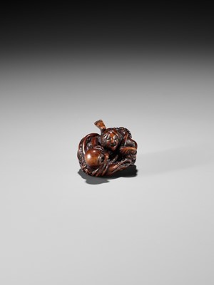 Lot 370 - KOKEI: A FINE WOOD NETSUKE OF AMA STRUGGLING WITH AN OCTOPUS