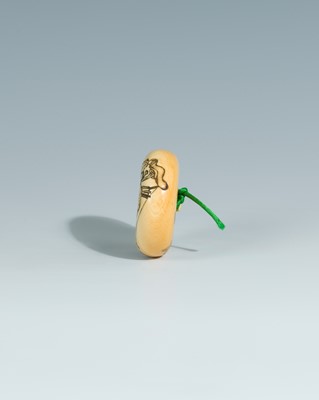 Lot 393 - YOSHITOMO: AN IVORY MANJU NETSUKE OF OTA DOKAN