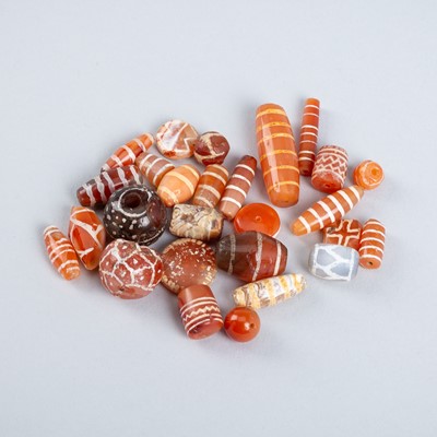 Lot 1554 - A FINE LOT WITH 25 ETCHED PYU CARNELIAN BEADS, c. 7TH – 9TH CENTURY