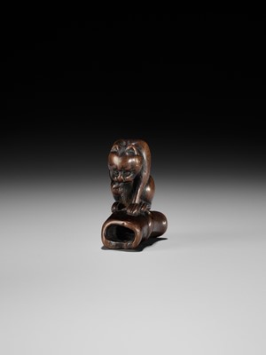 Lot 128 - A WOOD NETSUKE OF A TIGER ON BAMBOO