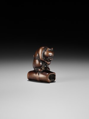 Lot 128 - A WOOD NETSUKE OF A TIGER ON BAMBOO