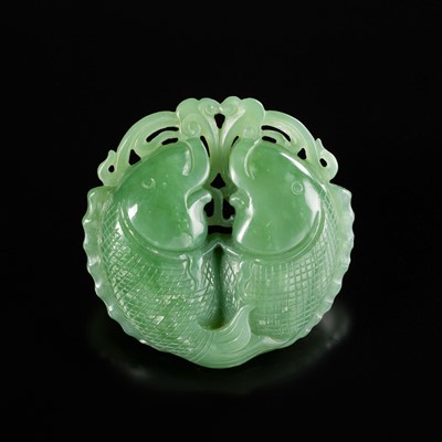 Lot 465 - A RETICULATED APPLE-GREEN JADEITE ‘TWIN FISH’ PENDANT, LATE QING DYNASTY TO REPUBLIC PERIOD