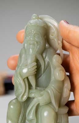 A JADE FIGURE OF AN IMMORTAL WITH FISH, LATE QING DYNASTY