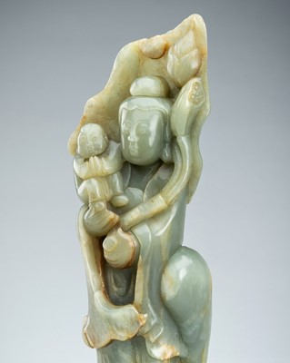 A CELADON BOWENITE FIGURE OF GUANYIN WITH CHILD