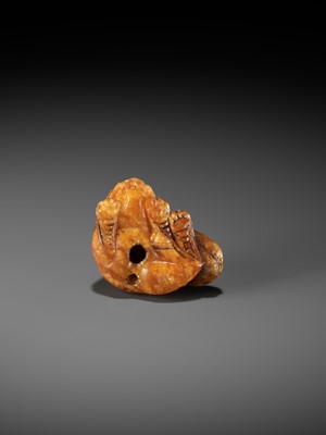 Lot 283 - A VERY RARE CLOUDY AMBER NETSUKE OF A RECUMBENT SHISHI
