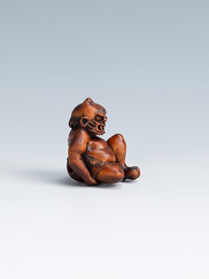 Lot 388 - MASAKAZU: A WOOD NETSUKE OF AN ONI SEATED ON A RAT