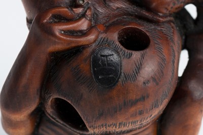 Lot 388 - MASAKAZU: A WOOD NETSUKE OF AN ONI SEATED ON A RAT