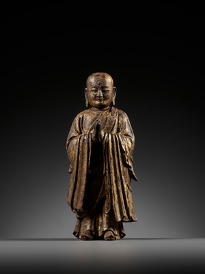 Lot 311 - A GILT-LACQUERED WOOD FIGURE OF ANANDA, YUAN TO MING DYNASTY