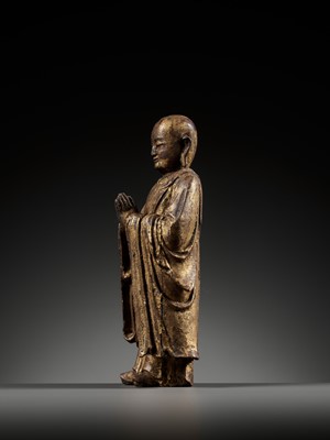 Lot 311 - A GILT-LACQUERED WOOD FIGURE OF ANANDA, YUAN TO MING DYNASTY