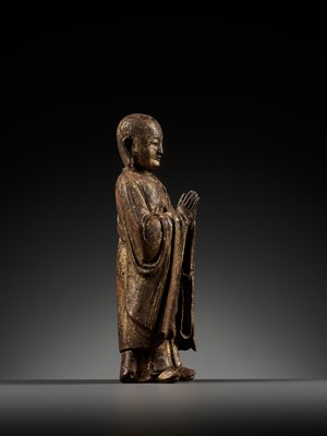 Lot 311 - A GILT-LACQUERED WOOD FIGURE OF ANANDA, YUAN TO MING DYNASTY