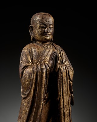 Lot 311 - A GILT-LACQUERED WOOD FIGURE OF ANANDA, YUAN TO MING DYNASTY