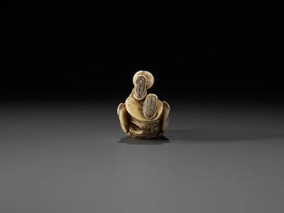 Lot 69 - AN OSAKA SCHOOL IVORY NETSUKE OF FUKUROKUJU PLAYING KEMARI