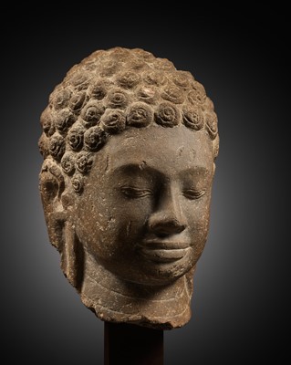 Lot 166 - A STONE HEAD OF BUDDHA, MON DVARAVATI PERIOD, 7TH-9TH CENTURY