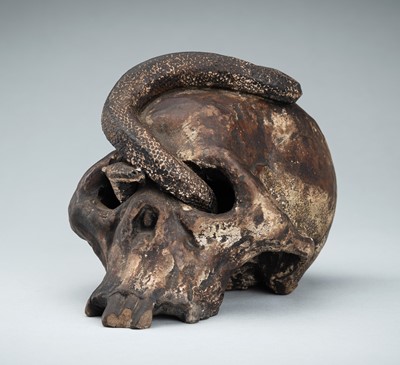 Lot 255 - A LIFESIZE CERAMIC MEMENTO MORI OF A SKULL WITH A SNAKE