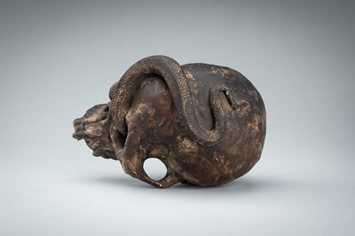 Lot 255 - A LIFESIZE CERAMIC MEMENTO MORI OF A SKULL WITH A SNAKE