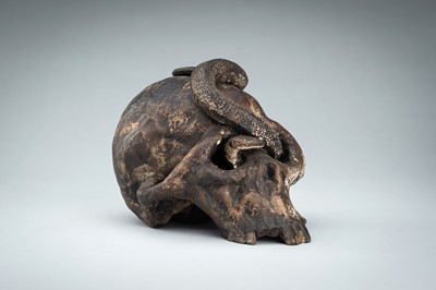 Lot 255 - A LIFESIZE CERAMIC MEMENTO MORI OF A SKULL WITH A SNAKE