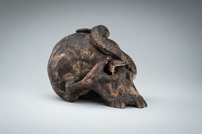 Lot 255 - A LIFESIZE CERAMIC MEMENTO MORI OF A SKULL WITH A SNAKE