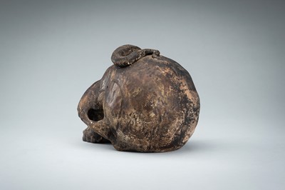Lot 255 - A LIFESIZE CERAMIC MEMENTO MORI OF A SKULL WITH A SNAKE