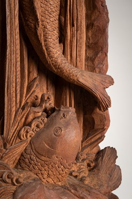 A WOOD CARVING OF CARP IN A WATERFALL