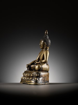 AN INLAID BRONZE FIGURE OF BUDDHA, TIBET, 13TH-14TH CENTURY