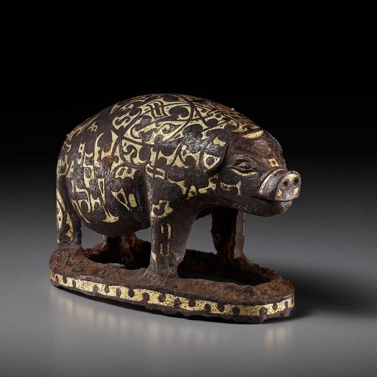 Lot 66 - A GOLD AND SILVER-INLAID IRON FIGURE OF A PIG, WARRING STATES PERIOD TO HAN DYNASTY