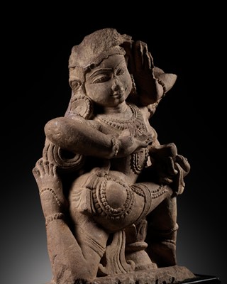 Lot 245 - A PINK SANDSTONE FIGURE RELIEF OF A DANCING YAKSHI, 11TH-12TH CENTURY