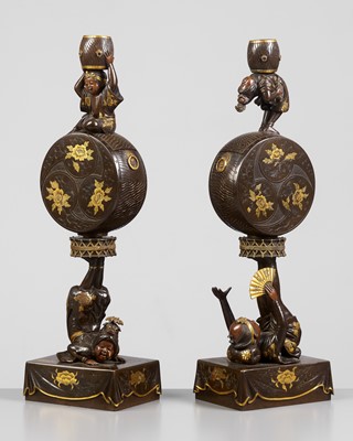 Lot 16 - MIYAO: A SUPERB PAIR OF PARCEL GILT MIXED-METAL CANDLESTICKS DEPICTING ACROBATS