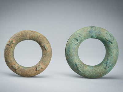 Lot 1498 - A PAIR OF BRONZE ‘FROG AND BULL’ RITUAL BANGLES, DONG SON STYLE