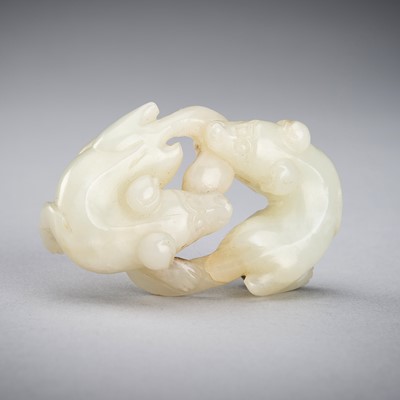 Lot 877 - A PALE CELADON JADE ‘DOUBLE BADGER’ GROUP, QING DYNASTY