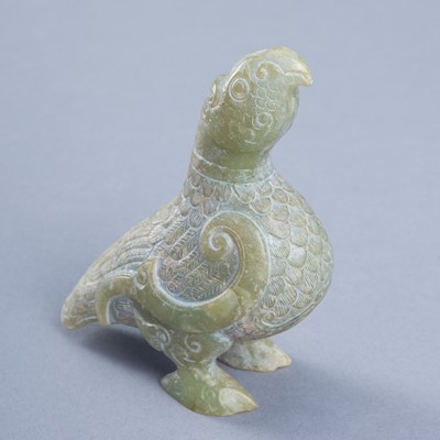 AN ARCHAISTIC CELADON JADE FIGURE OF A BIRD