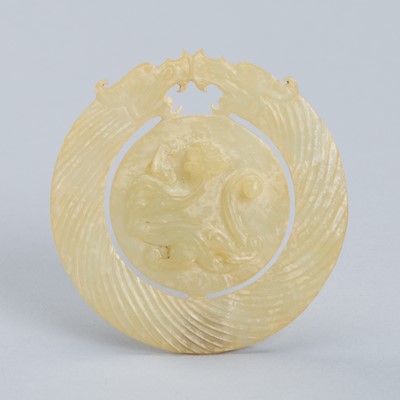 AN ARCHAISTIC YELLOW JADE ‘DRAGON’ BI DISC