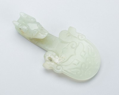 A PALE CELADON JADE ‘DRAGON’ BELT HOOK, 19TH CENTURY OR LATER