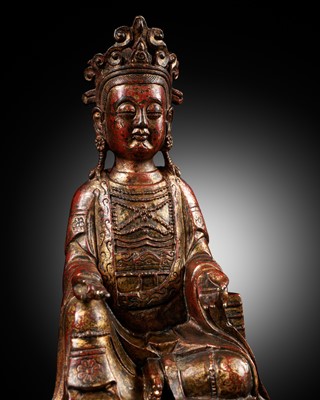 Lot 1558 - A RED AND GILT-LACQUERED BRONZE FIGURE OF GUANYIN, LATE 19TH CENTURY