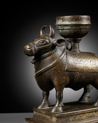 Lot 640 - A BRONZE OIL LAMP WITH A FIGURE OF NANDI, SOUTH INDIA, 17TH-18TH CENTURY