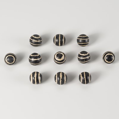 Lot 1558 - A LOT WITH 11 PYU GHOST EYE HARDSTONE BEADS, 7th – 9th CENTURY