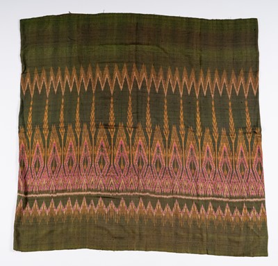 Lot 986 - A KHMER TRIBAL GREEN-GROUND SILK IKAT TEXTILE, 1900s