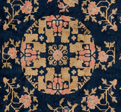 A BLUE-GROUND WOOL ‘PEONY AND LOTUS’ CARPET, QING DYNASTY